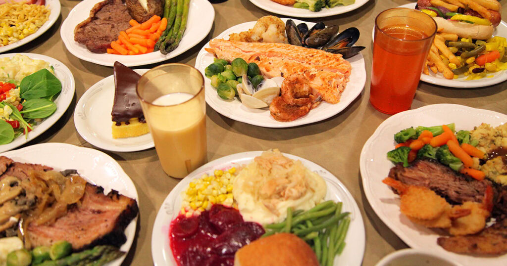 Plates full of salmon and other food dishes